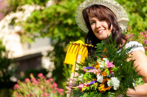 Workers wearing PPE and maintaining garden machinery
