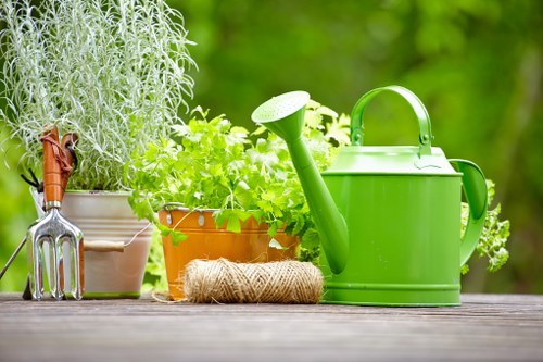 Green waste being bagged for removal in a small garden